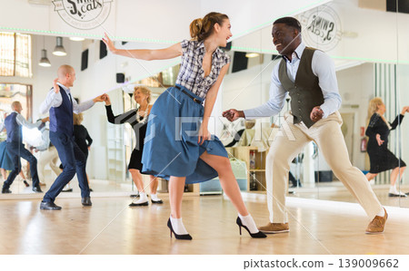 Man and woman performing jazz dance in dancing room 139009662