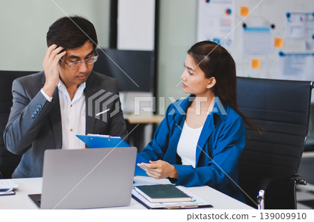 Millennial Asian stressed depressed worried thoughtful professional male businessman female businesswoman employee staff in formal business suit sitting thinking solving problem ideas in office room Millennial Asian stressed depressed worried thoughtful professional male businessman female businesswoman employee staff in formal business suit sitting thinking solving problem ideas in office room 139009910
