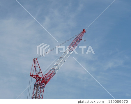 A crane extending into the blue sky A crane extending into the blue sky 139009970