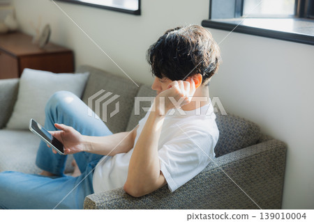 Young man looking at a smartphone Young man looking at a smartphone 139010004