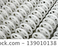 White plastic rollers of industrial conveyor, production, sorting, or transportation line 139010138