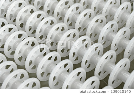 White plastic rollers of industrial conveyor, production, sorting, or transportation line White plastic rollers of industrial conveyor, production, sorting, or transportation line 139010140