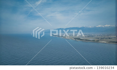A hazy landscape of offshore breakwaters, seawalls, and windbreaks around the Shimoshinkawa coast in eastern Toyama Prefecture. A hazy landscape of offshore breakwaters, seawalls, and windbreaks around the Shimoshinkawa coast in eastern Toyama Prefecture. 139010234
