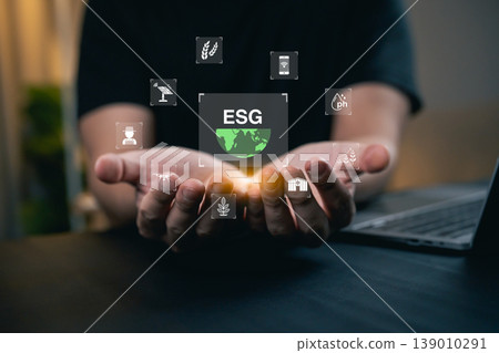 Hands Holding Symbols of Environmental, Social, and Governance Concepts with ESG Logo and Icons Representing Sustainability and Responsibility 139010291