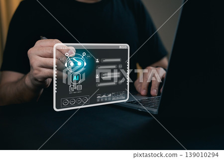 Hands Engaging with Futuristic AI Interface on a Transparent Display Above a Laptop in a Dimly Lit Workspace Hands Engaging with Futuristic AI Interface on a Transparent Display Above a Laptop in a Dimly Lit Workspace 139010294