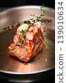 Beef roast with thyme and garlic on a stainless steel cooking pan 139010634