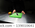 Chef preparing mango on green cutting board with knife in kitchen 139010641