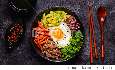 Traditional Korean dish Bibimbap: rice with vegetables beef and egg. 139010773