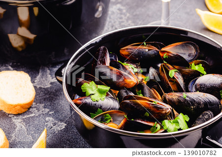 Delicious seafood mussels with sauce and parsley. Delicious seafood mussels with sauce and parsley. 139010782