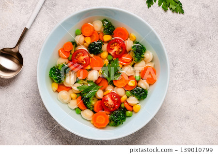 Soup with mini dumplings and vegetables. 139010799
