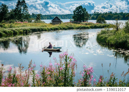 A man is fishing in a boat. A man is fishing in a boat. 139011017