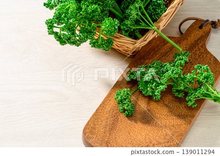 Vibrantly green parsley placed on a wooden board Vibrantly green parsley placed on a wooden board 139011294