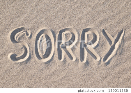 Word Sorry written on sand, close up. Concept of apologising and sorrowful mood Word Sorry written on sand, close up. Concept of apologising and sorrowful mood 139011386
