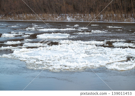 Parts of ice on river. Big river covering in ice floating on the surface 139011453