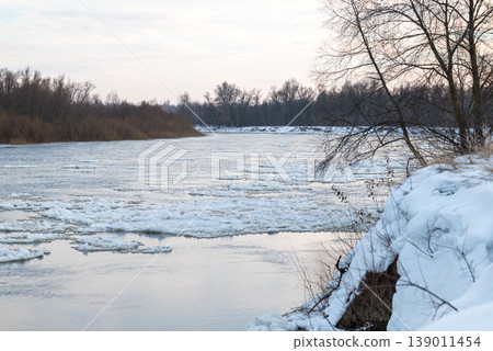 River with many ice parts flowing on the surface. River in winter, ice on the water surface River with many ice parts flowing on the surface. River in winter, ice on the water surface 139011454