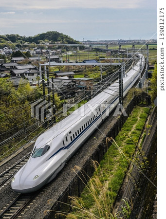 The brand new J22 700 series Shinkansen speeds by. 139012175