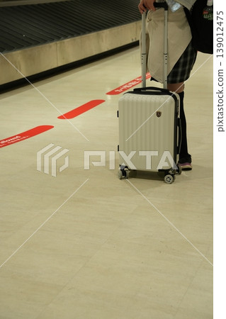 A woman with a suitcase at the airport A woman with a suitcase at the airport 139012475