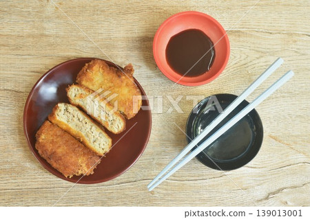 Menchi Katsu fried mashed pork with onion coating flake bread and egg dipping sweet shoyu sauce Japanese food on plate 139013001