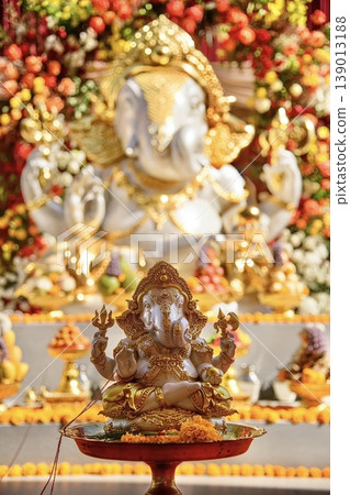 Ornate Lord Ganesha Idol with Golden Decorations for Hindu Festival Celebration and Puja Ornate Lord Ganesha Idol with Golden Decorations for Hindu Festival Celebration and Puja 139013188