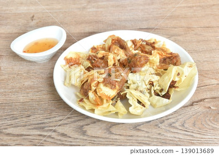 crispy fried dumpling tofu skin stuffed chop pork and shrimp dipping sweet plum sauce on plate 139013689