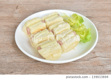 roll bread stuffing pork ham and cheese with fresh cos lettuce on plate roll bread stuffing pork ham and cheese with fresh cos lettuce on plate 139013694