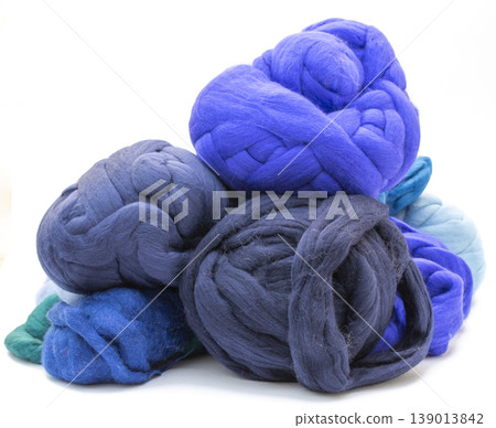 Multicolored skeins of merino wool on a white background 139013842