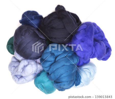 Multicolored skeins of merino wool on a white background Multicolored skeins of merino wool on a white background 139013843