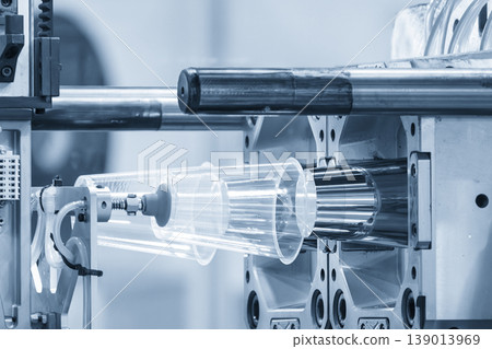 Automatic material handling process of plastic glasses from an injection molding machine in a modern factory. Automatic material handling process of plastic glasses from an injection molding machine in a modern factory. 139013969
