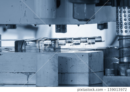 Mass production of electric terminal parts using a high-precision progressive die in a modern industrial setting. Mass production of electric terminal parts using a high-precision progressive die in a modern industrial setting. 139013972