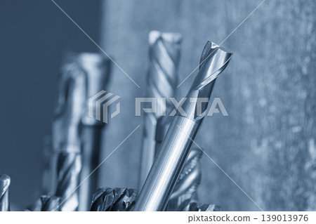 Inclined view of a professional flat nose end mill tool in a high-tech CNC machining environment. Inclined view of a professional flat nose end mill tool in a high-tech CNC machining environment. 139013976