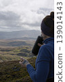 Woman hydrating during a highland mountain hike 139014143