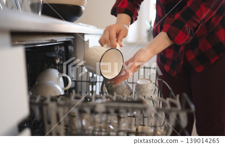Young Girl Helps With Dishes in Modern Kitchen Setting 139014265