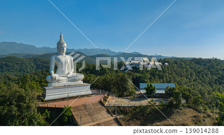 Aerial view of whit big Buddha on the hill of Wat Phra That Pu Jae 139014288