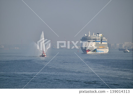 The luxury cruise ship "AIDA Diva" is welcomed with a colored water cannon from a fireboat upon entering Kobe Port. The luxury cruise ship "AIDA Diva" is welcomed with a colored water cannon from a fireboat upon entering Kobe Port. 139014313