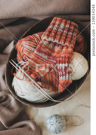Hand knitted socks with needles and yarn ball. Concept for handmade and hygge slow life. 139014348