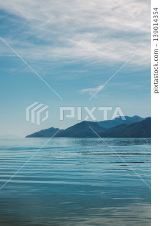 Amazing view of Skadar Lake and beautiful mountains on a sunny morning. Travel destination in Montenegro. Amazing view of Skadar Lake and beautiful mountains on a sunny morning. Travel destination in Montenegro. 139014354