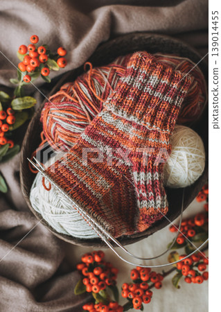 Hand knitted socks with needles and yarn ball. Concept for handmade and hygge slow life. 139014455