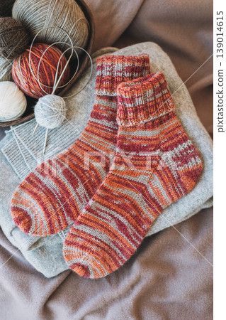 Hand knitted socks with needles and yarn ball. Concept for handmade and hygge slow life. 139014615