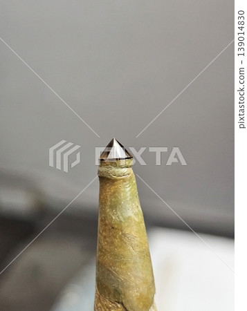 Macro Shot of a Brown Faceted Diamond on a Lapidary Dop Stick for Cutting and Polishing Macro Shot of a Brown Faceted Diamond on a Lapidary Dop Stick for Cutting and Polishing 139014830