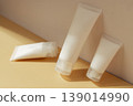 Minimal cosmetic tubes with skincare cream on pastel background in warm sunlight, beauty product packaging concept 139014990
