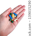 Hand holding pills capsules medicine vitamins supplements isolated on transparent background for pharmacy health use, medical dosage, wellness care and treatment routine. 139015290