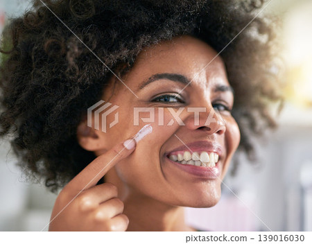Portrait, woman and hand with moisturiser for skincare, treatment and facial in home. Black person, happy and smile for dermatology, result and hydration with collagen boost, lotion and sunscreen Portrait, woman and hand with moisturiser for skincare, treatment and facial in home. Black person, happy and smile for dermatology, result and hydration with collagen boost, lotion and sunscreen 139016030
