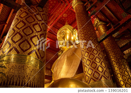 Golden the huge Buddha statue enshrined in Wat Phanan Choeng, called Wat Luang Pho Tho in Ayutthaya, Thailand. Golden the huge Buddha statue enshrined in Wat Phanan Choeng, called Wat Luang Pho Tho in Ayutthaya, Thailand. 139016201