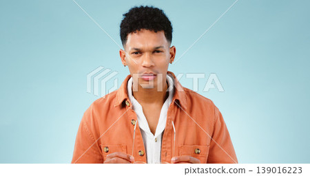 Man, confused and portrait in studio with thinking mindset, doubt and problem with choice in mockup. Young person, brazilian and unsure face with question, idea error and decision by blue background Man, confused and portrait in studio with thinking mindset, doubt and problem with choice in mockup. Young person, brazilian and unsure face with question, idea error and decision by blue background 139016223