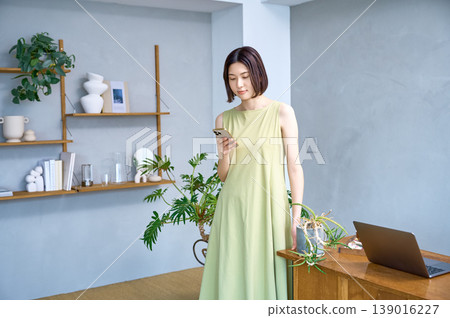 The lifestyle of a young Japanese woman using her smartphone in her room 139016227