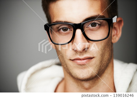 Closeup, portrait and man with glasses in studio for eye care mock up on gray background in Spain. Male model, person and vision with facial expression for spectacles by correction, lens or sight Closeup, portrait and man with glasses in studio for eye care mock up on gray background in Spain. Male model, person and vision with facial expression for spectacles by correction, lens or sight 139016246