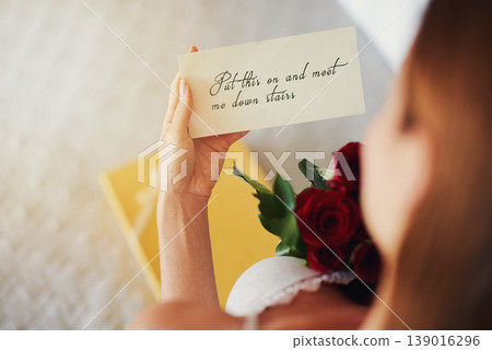 Woman, roses and letter with gift in bedroom on birthday, celebration and valentines day event in home. Girl, reading notes and back with bouquet, flowers and invitation with announcement in house 139016296