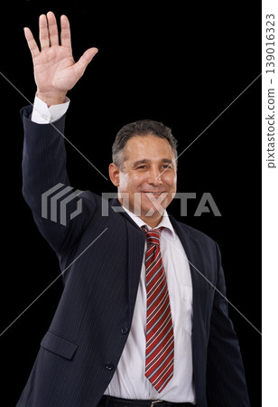 Government, politician and man on black background with hand for wave, greeting and support. Success, political campaign and person with gesture for leadership, pride and winning election in studio 139016323