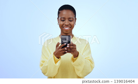 Happy woman, smile or texting on mobile app in studio for mockup of social media on blue background. Black person, face and looking at screen for email, message or reading on internet, online or web Happy woman, smile or texting on mobile app in studio for mockup of social media on blue background. Black person, face and looking at screen for email, message or reading on internet, online or web 139016404