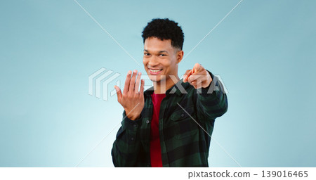 Man, pointing and invitation for welcome in studio, offer and choice on blue background. Model, happy face and hand gesture for sign up in promotion, deal opportunity and advertising for mockup space Man, pointing and invitation for welcome in studio, offer and choice on blue background. Model, happy face and hand gesture for sign up in promotion, deal opportunity and advertising for mockup space 139016465